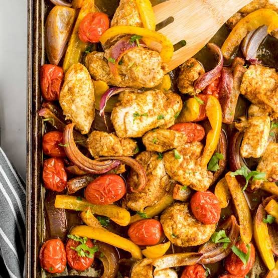 Easy homemade no fuss sheet pan chicken shawarma with roasted peppers, tomatoes served in a tray