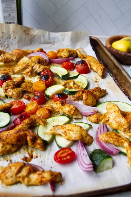 Homemade sheet pan chicken shawarma with roasted tomatoes, carrots, onions and zuchini 