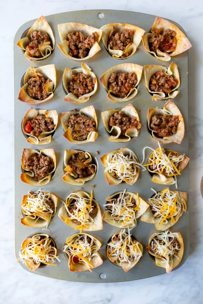 beef taco cups in a baking tray ready for the oven