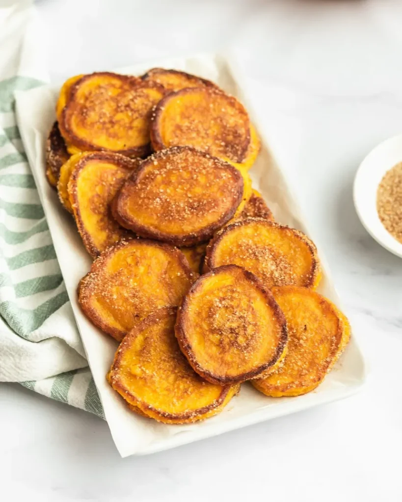 homemade pumpkin fritters sprinkled with sugar and cinnamon