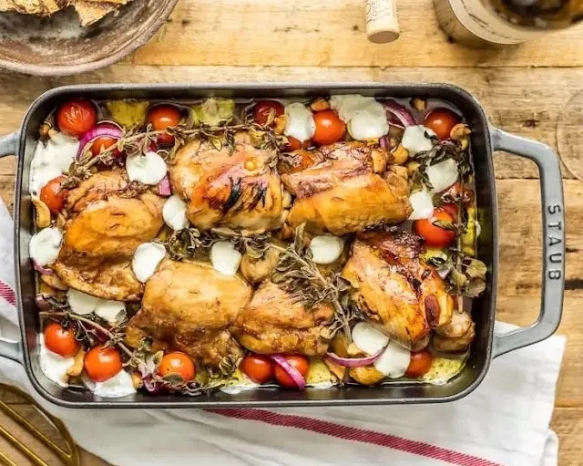 Easy one tray Mediterranean Chicken Balsamic Traybake  in a big rectangular tray served on a table with white table cloth