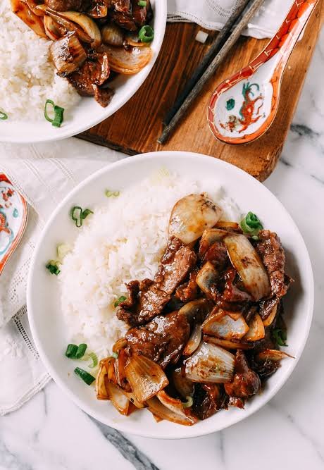 homemade beef onion stir fry served with rice in a round bowl