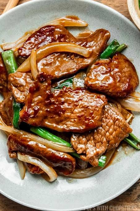 beef onion stir fry served in a white plate