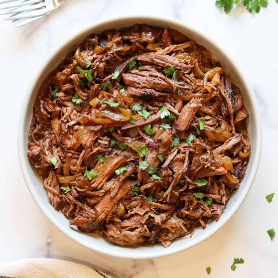 Easy one pot shredded beef in a white round bowl