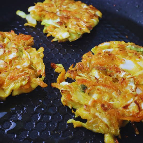 crispy cabbage fritters fried in skillet