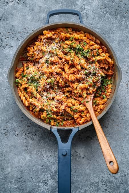 Homemade One Pot cajun beef pasta with wooden spoon on a table
