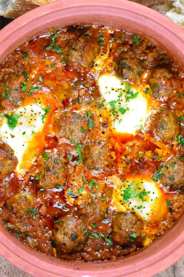 Easy moroccan beef tagine with meatballs topped with melted cheese and parsley