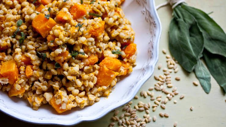 easy butternut and barley risoot served on a plate. With fresh sage and uncooked barley on the side. pearl barley butternut 