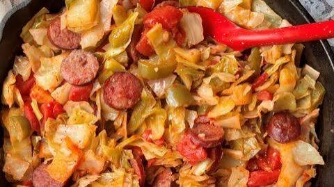 delicious weeknight dinner one pot cabbage and sausage in a black pan